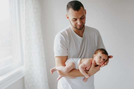 dad holding baby in football hold position