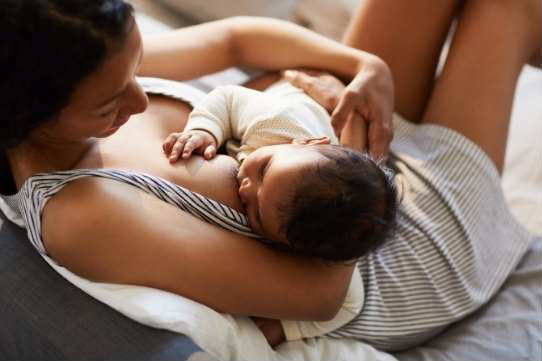 mom breastfeeding in reclined position